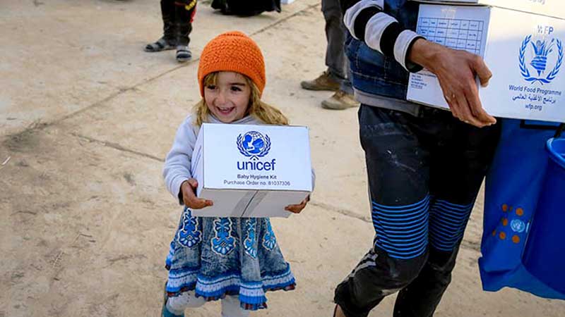 a girl walks away from an aid di